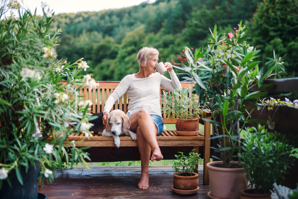woman relaxing in her garden with her dog